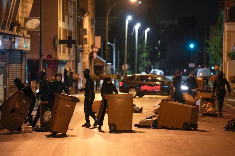 Protesters block a street with garbage cans in Colombes, outside Paris. Photograph: Lewis Joly/AP