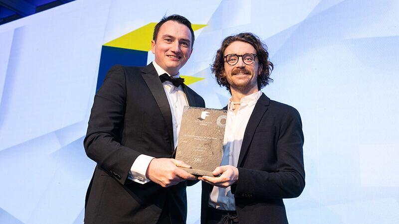 Dave Merriman, director, T&I Fitouts, presents the Fit Out Designer of the Year - Rising Star award to Conor Dunne, TapCreative.