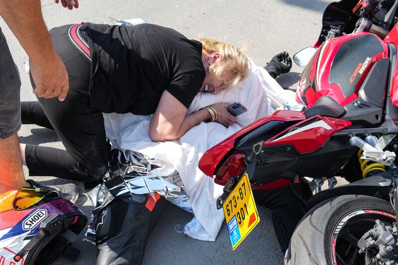 An Israeli woman weeps over the covered corpse of her nephew who was shot dead in the southern city of Sderot. Photogaph: Baz Ratner/AFP via Getty Images