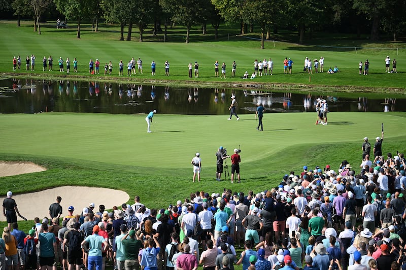 Rory McIlroy putts on the 18th green as crowds look on at The K Club. Photograph: Ross Kinnaird/Getty Images