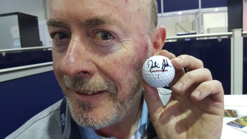 Philip Reid with the golf ball he was hit by, signed by Dustin Johnson.