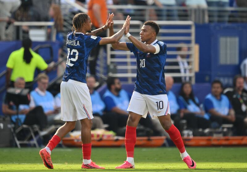 Kylian Mbappé celebrates scoring France's opening goal with team-mate Bradley Barcola. Photograph: Angela Weiss/AFP via Getty Images