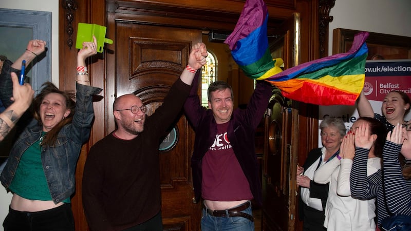 Michael McCartan celebrates with his partner Malachi O’Hara (centre) of the Green Party at Belfast City Hall. Photograph: Mark Marlow/PA Wire