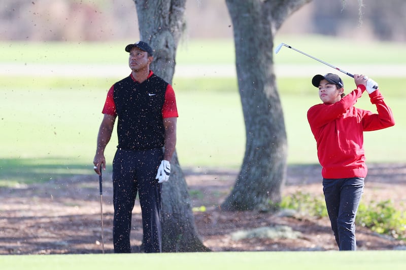 Charlie Woods plays a shot as Tiger Woods looks on at the PNC Championship at Ritz-Carlton Golf Club in Orlando, Florida. Photograph: Mike Ehrmann/Getty Images