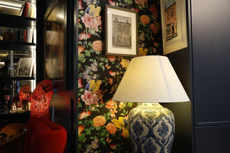 Bold floral wallpaper covers two of the ground-floor walls