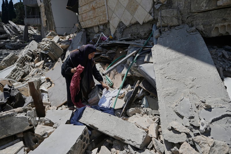 Hanan Qubaisi collects belongings from her house destroyed in previous Israeli airstrikes in Nabatiyeh, southern Lebanon, on Thursday. Photograph: Bilal Hussein/AP