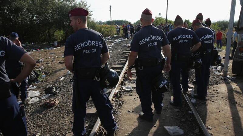 Hungarian police block the rail track at the Hungarian-Serbian border preventing migrants crossing before new laws come in to force at midnight on Monday.  Photograph: Getty