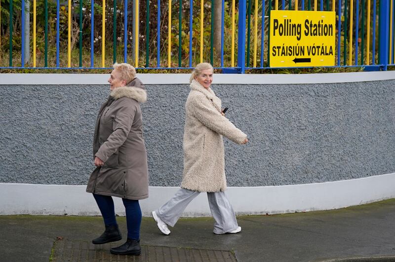 People walk to  and from a polling station at the Deaf Village in Dublin's Cabra this morning. Photograph: Niall Carson/PA Wire