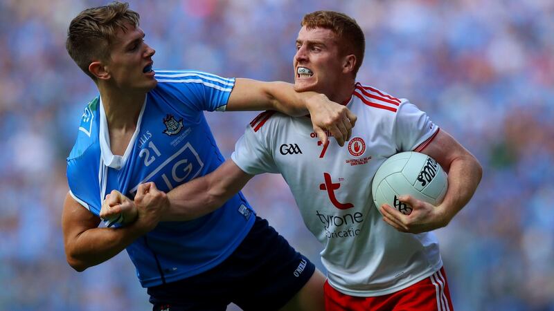 Peter Harte tangles with Michael Fitzsimons. Photo: Tommy Dickson/Inpho