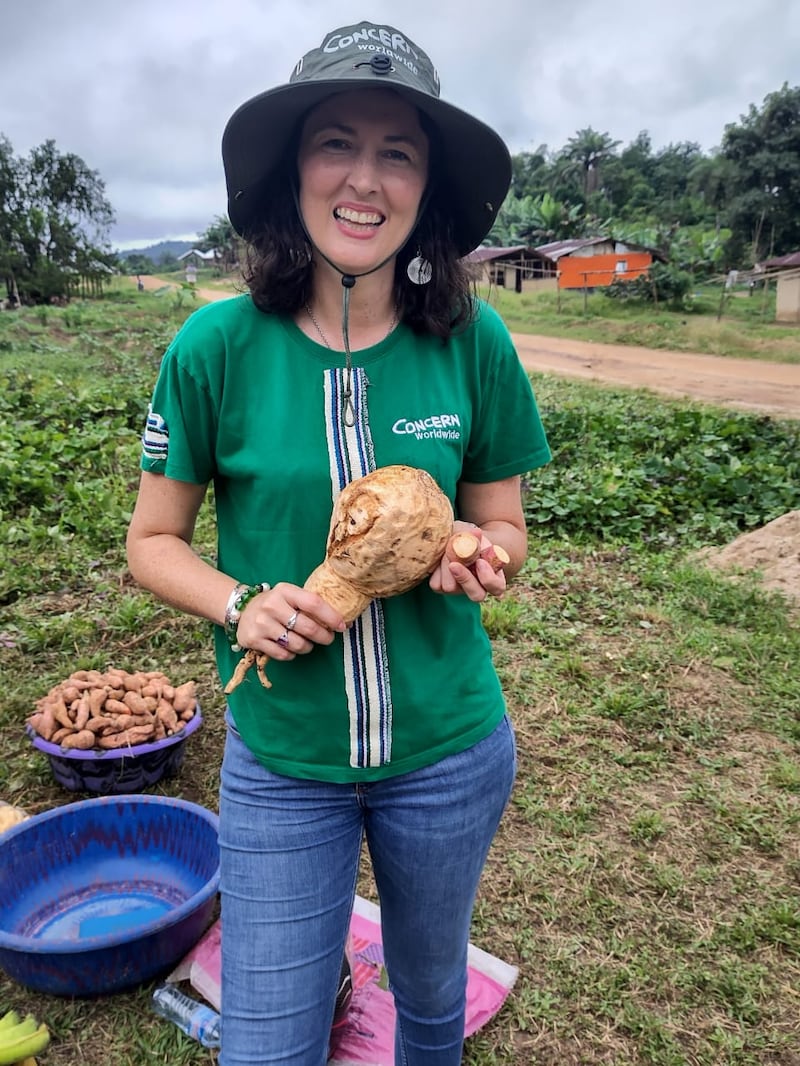 Ciara Begley, country director for Liberia at international aid charity Concern, holding a freshly harvested orange-fleshed sweet potato