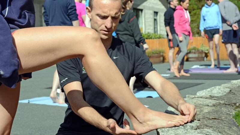Above: Athletes are instructed in running techniques at the masters of running workshop in Brockagh Resource Centre, Laragh, Co Wicklow. Below: Jason Kehoe gives some tips to Lucy O’Malley. Photographs: Eric Luke