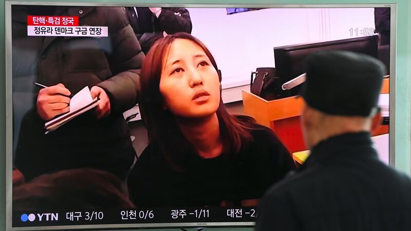 People in Seoul watch a screen showing a news report on the arrest in Denmark on Sunday of Chung Yoo-ra, the 20-year-old daughter Choi Soon-sil,  who is at the centre of   corruption allegations in South Korea. Photograph: Jung Yeon-Je/AFP/Getty Images