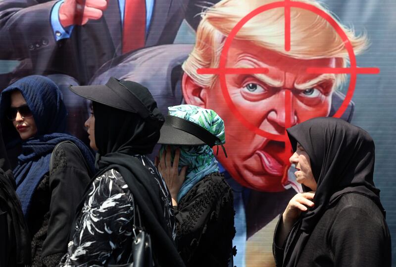 Iranians walk past an anti-Trump banner in Tehran, Iran. Photograph: EPA