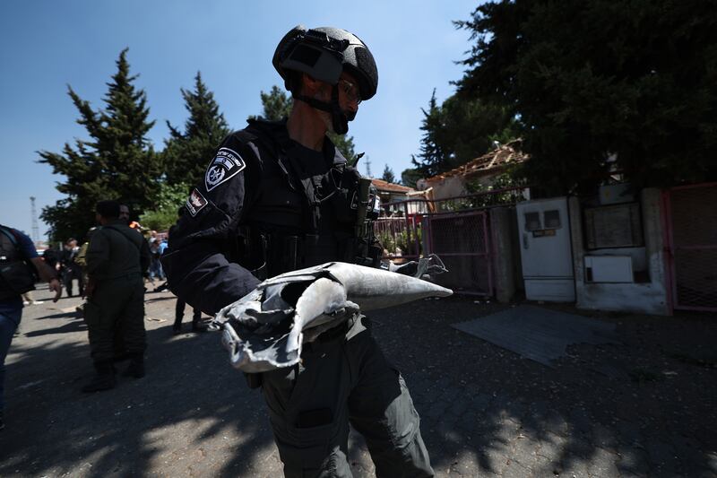 Israeli police carry the remains of a rocket fired from southern Lebanon which  hit a house in the city of Safed in the Upper Galilee. Photograph: Atef Safadi/AFP