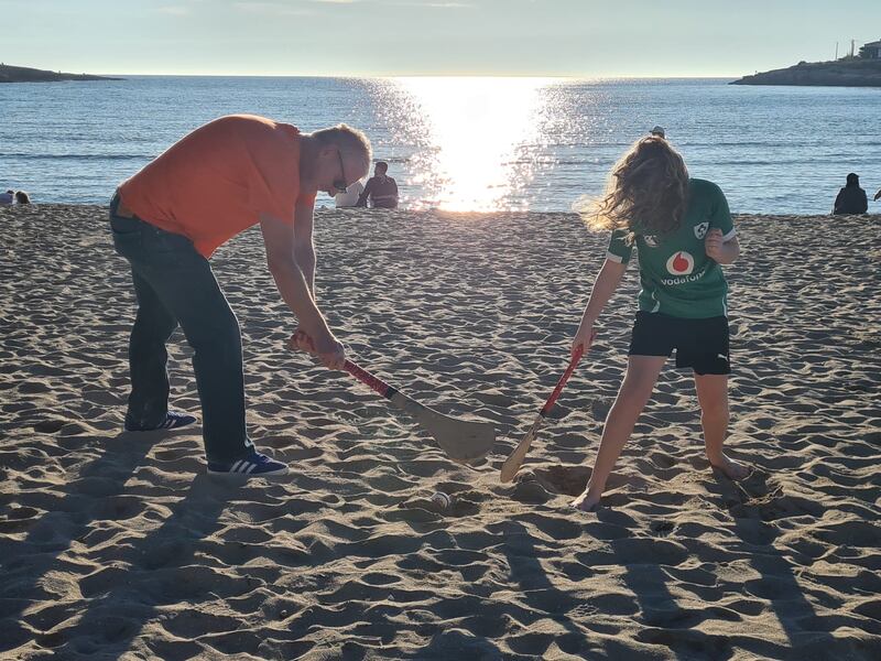 Conal Taylor and his daughter Derval playing hurling on their local beach in France.