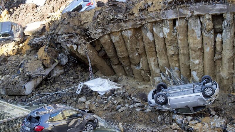 Cars are towed away after a sinkhole that opened up. Photograph: Massimo Percossi/EPA