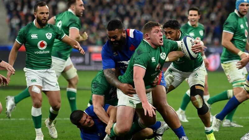 Tadhg Furlong of Ireland is tackled by Uini Atonio. Photograph:  Mike Hewitt/Getty