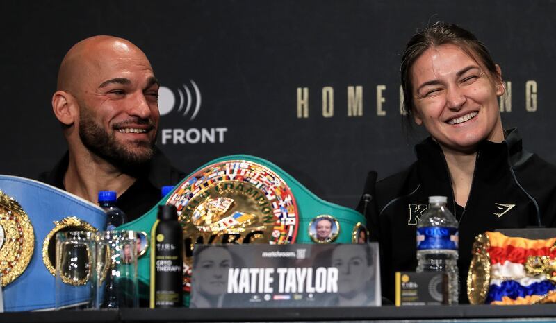 Katie Taylor and her coach Ross Enamait share a laugh during a press conference at Dublin Castle. Photograph: Gary Carr/Inpho