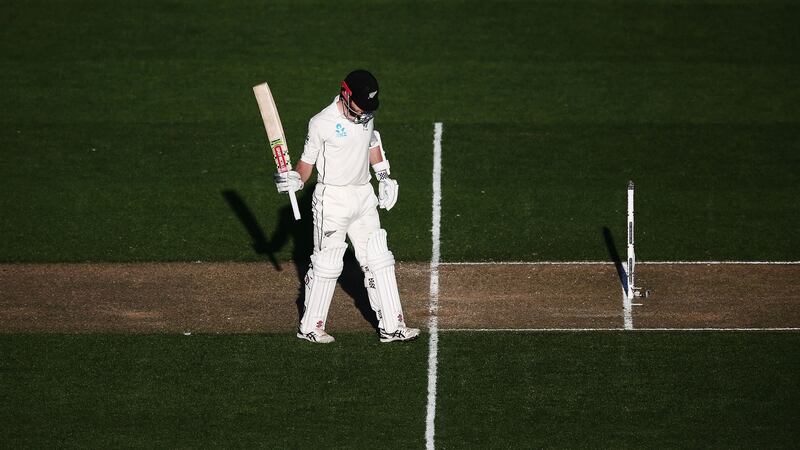 Kane Williamson of New Zealand acknowledges reaching his half century. Photograph:  Anthony Au-Yeung/Getty