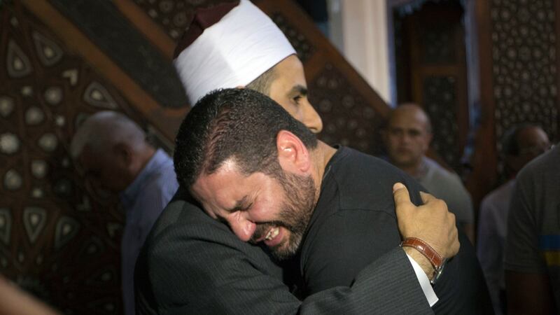 The Imam of al Thawrah Mosque Samir Abdel Bary hugs film director Osman Abu Laban,  who lost four relatives inThursday’s EgyptAir crash. Photograph: Amr Nabil/AP Photo