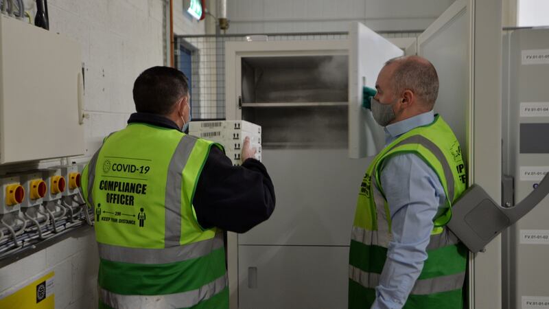 Specially trained members of the Cold Chain warehouse operations team   transfer boxes of Pfizer/BioNtech vaccine vials to ultra low temperature freezers.  Photograph: Alan Betson