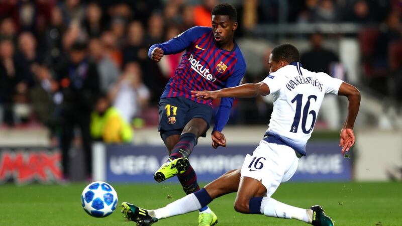 Ousmane Dembele scores  Barcelona’a first goal despite the challenge of Kyle Walkers-Peters of Tottenham Hotspur  during the  Champions League  match at the Nou Camp. Photograph: Clive Rose/Getty Images