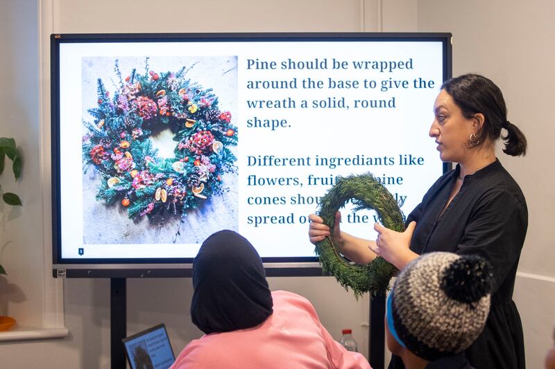 Róisín Godfrey explains the process at a wreath-making workshop. Photograph: Tom Honan 