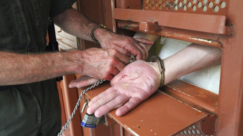 Solitary confinement: a  prisoner at the Pelican Bay State Prison  near Crescent City in  California has his hands shackled before his cell door is opened. Photograph: Jim Wilson/The New York Times