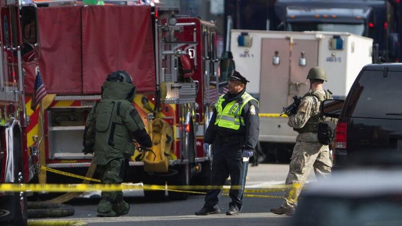 Bomb squad officials check a possible suspicious device near the scene of multiple explosions near the end of the Boston Marathon finish line in Boston today.  Photograph: Scott Eisen/Reuters