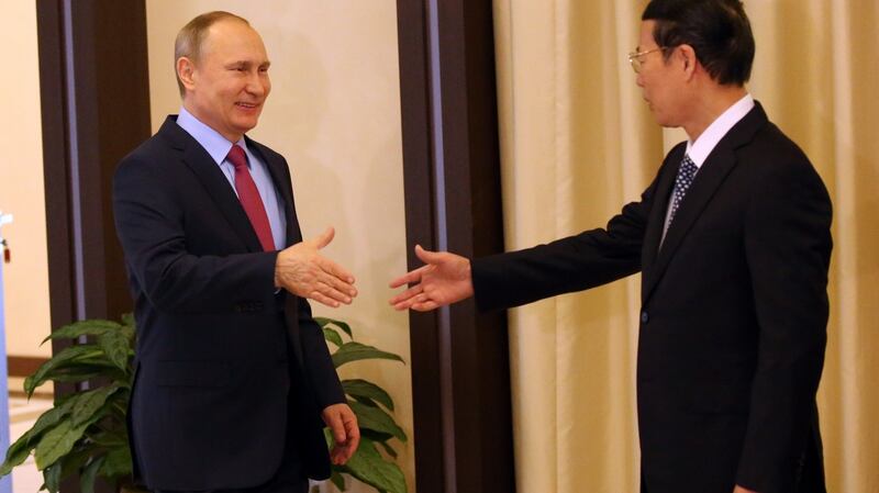 Russian president Vladimir Putin  greeting then Chinese vice-premier Zhang Gaoli. Photograph: Mikhail Svetlov/Getty Images