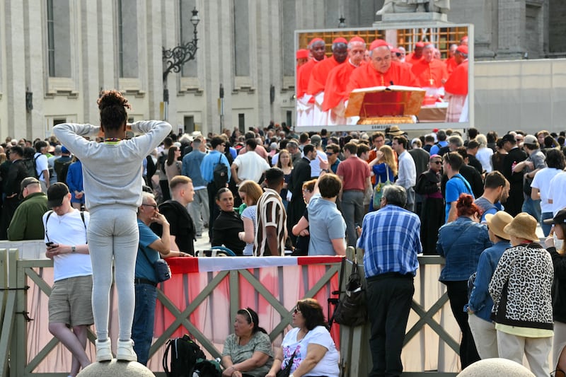 Crowds watch a giant screen displaying images of the cardinals in the Sistine chapel as the conclave to elect a new Pope starts, Photo: ANDREAS SOLARO/AFP via Getty Images         