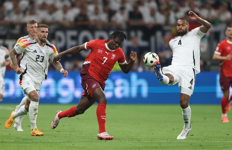 Jonathan Tah of Germany attempts to control the ball whilst under pressure from Breel Embolo. Photograph: Lars Baron/Getty