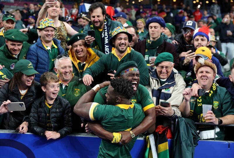 Siya Kolisi of South Africa celebrates victory with members of the crowd at full-time. Photograph: Chris Hyde/Getty Images