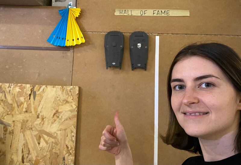 Platoon commander Lt Yulia Mykytenko at the unit's “hall of fame” wall for the longest-surviving drones. Photograph: Lara Marlowe