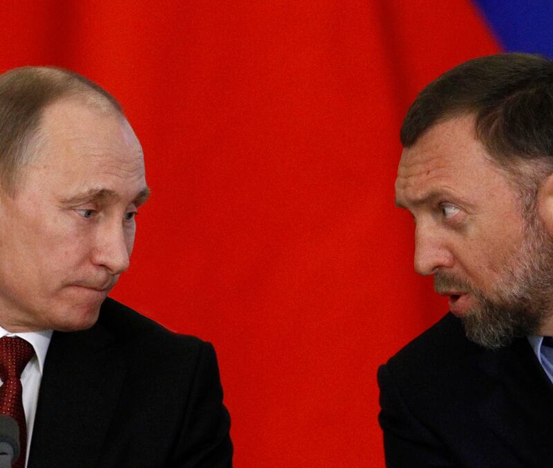 Russia's President Vladimir Putin (L) and Russian tycoon Oleg Deripaska