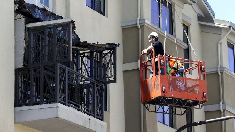 Workmen examine  damage at the scene of a 4th-story apartment building balcony collapse in Berkeley, California,  June 16th, 2015. File photograph: Elijah Nouvelage/Reuters
