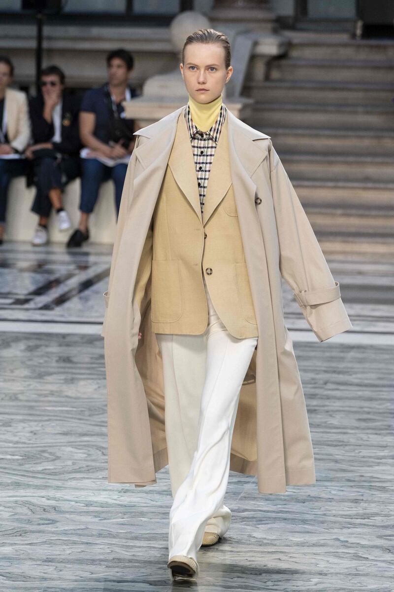 Contrasts:  A white coat shrugged over a gingham check suit. Photograph: Niklas Halle’n/AFP/Getty