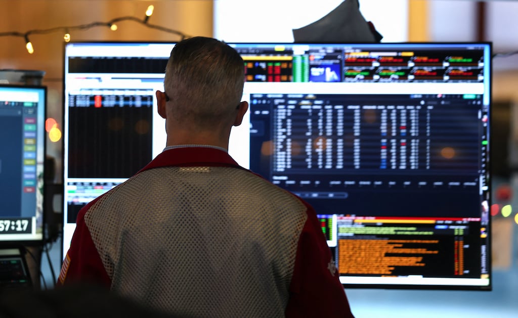A trader works at his desk on the floor of the New York Stock Exchange. What will happen to stocks in 2026? Photograph: Timothy A Clary/AFP via Getty Images