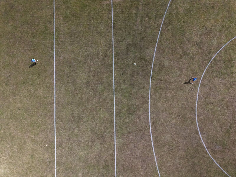 Two footballers practise on a dried-out grass GAA pitch at St Anne's Park, Dublin. Photograph: Alan Betson