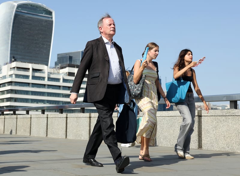 Commuters walk in the sun as they cross London Bridge , during a heatwave, in central London on June 24th, 2026. Photograph: Toby Shepheard / AFP via Getty Images.