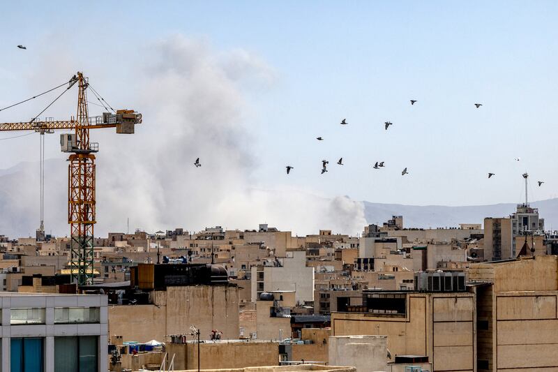 Smoke rises in the distance in Tehran, following a US-Israeli air strike in late February. Photograh: Arash Hhamooshi/The New York Times