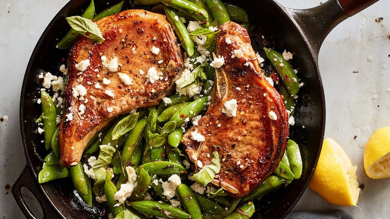 One-pan pork chops with feta, sugar snap peas and mint. Photograph: Johnny Miller/The New York Times.