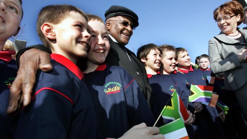Desmond Tutu with schoolchildren at the launch of the Music Room, a Ballymun Regeneration project, in Ballymun, Dublin. File photograph: Eric Luke/The Irish Times