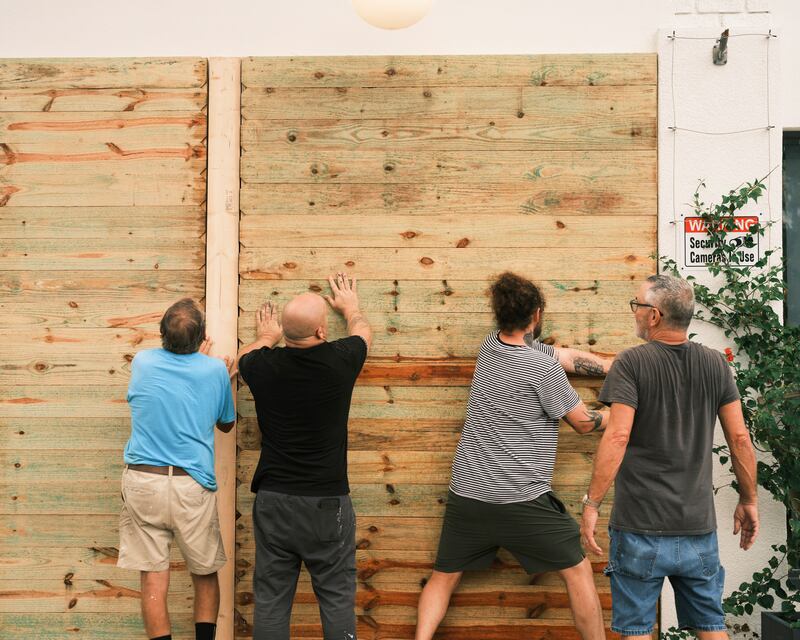 Residents install wood panels to protect windows in St Petersburg, Florida. Governor Ron DeSantis warned residents to brace for a 'ferocious' storm. Photograph: Zack Wittman/The New York Times
                     
                      
