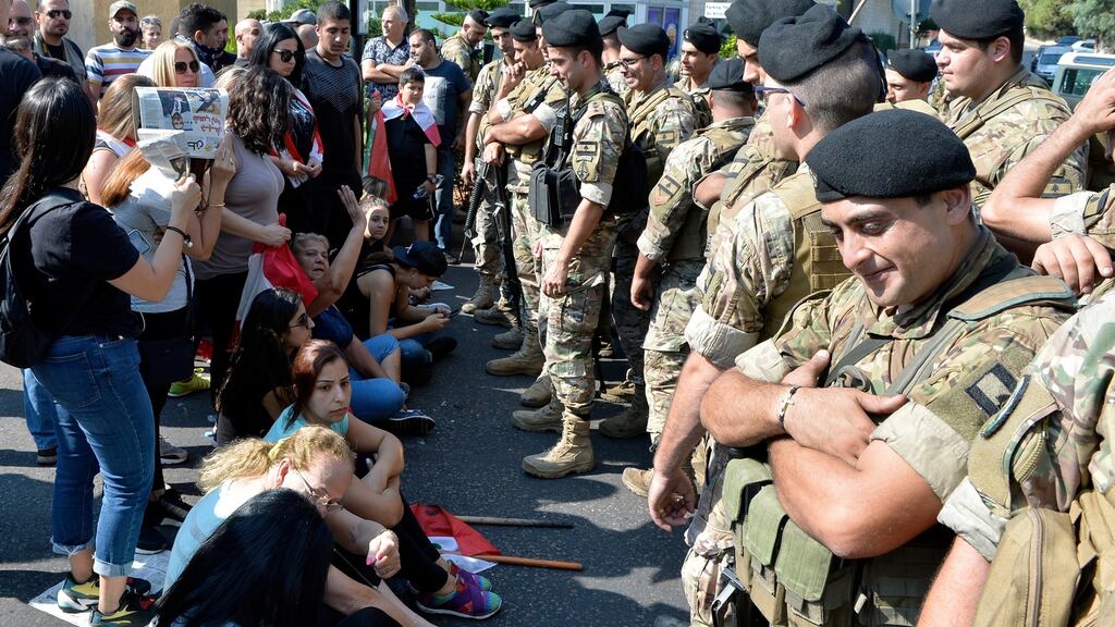 Protesters in front of Lebanese soldiers as they block a road east of Beirut. Photograph: Wael Hamzeh/EPA