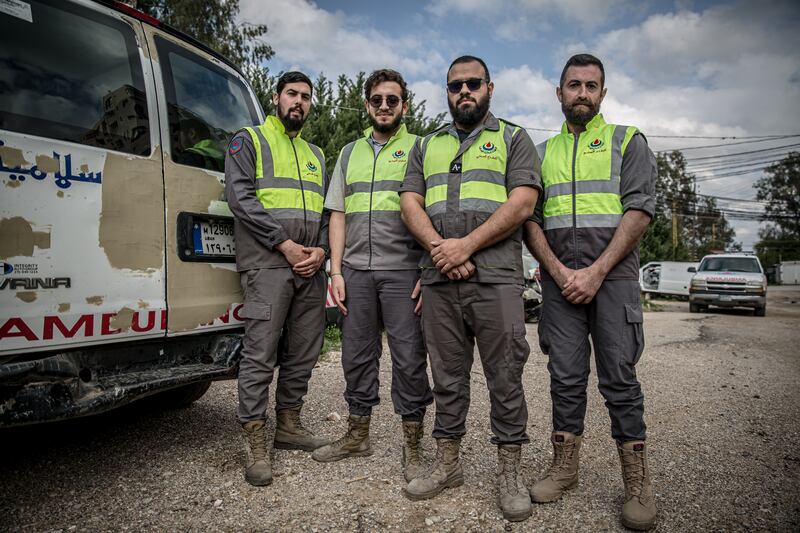 First responders who work with the Hezbollah-linked Islamic Health Organisation beside an ambulance damaged in the conflict in Tyre, a city in southern Lebanon also known as Sour, 20km from the border with Israel. Photograph: Sally Hayden