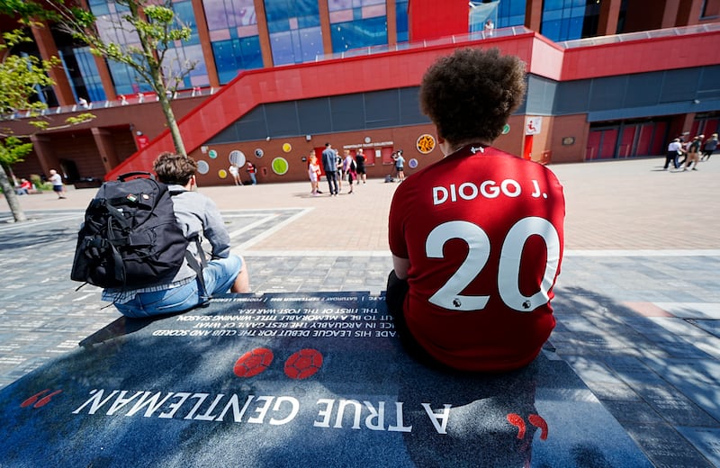 A Liverpool fan at Anfield Stadium, home of Liverpool, after laying a tribute in memory of Diogo Jota who has died at the age of 28. Photograph: Peter Byrne/PA