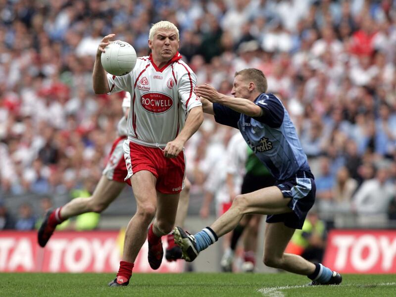 Tyrone's Owen Mulligan goes past Stephen O'Shaughnessy of Dublin on his way to scoring a goal in the 2005 quarter-final. Photograph: Tom Honan/Inpho