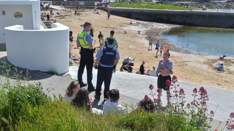 Gardaí check addressed of visitors to Sandycove, Dublin after it and the 40ft reopened on the first day of Covid-19 Restrictions being eased. Photograph: Alan Betson.