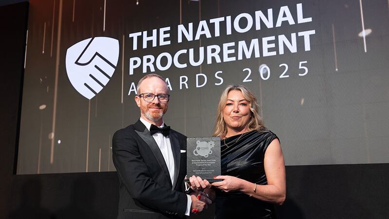 Michael Walls, awards judge, presents the best public sector, semi state or government procurement project of the year award to Angela Larkin, National Broadband Ireland (NBI).
